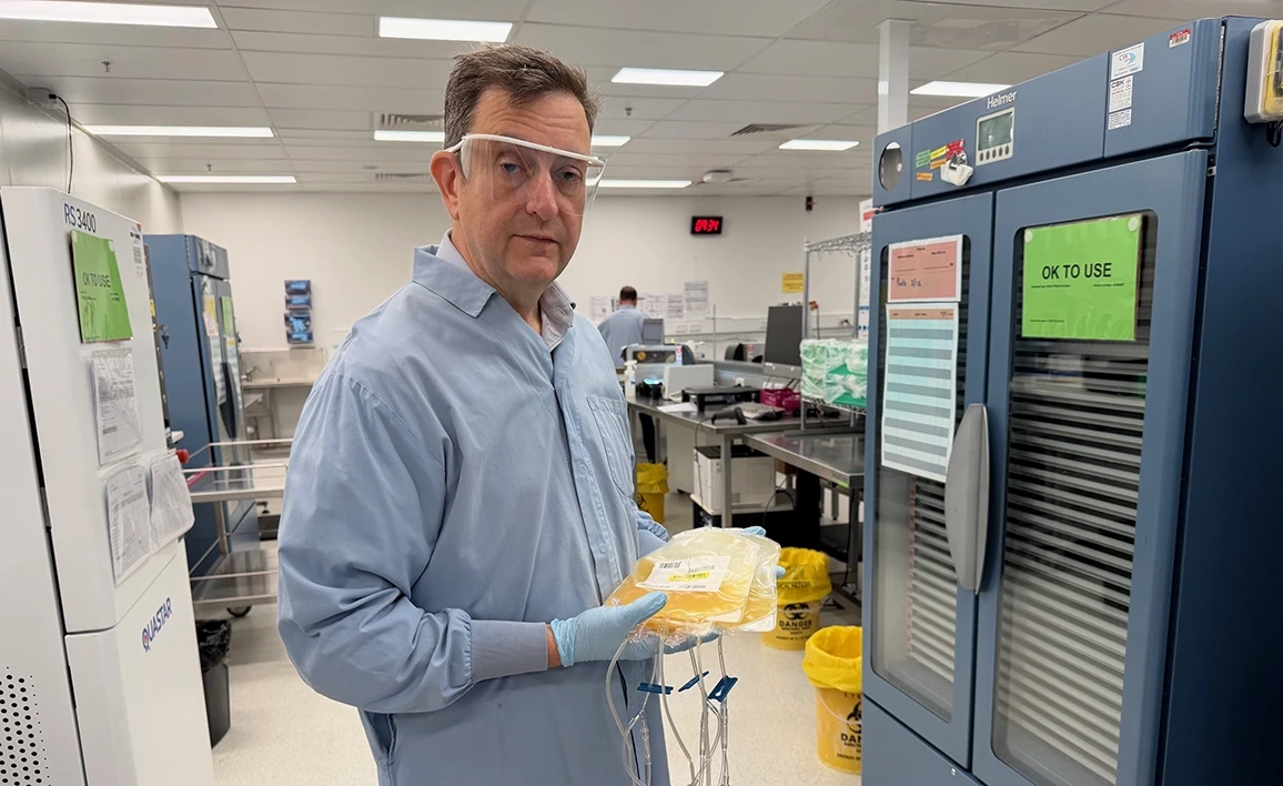 Prof Michael Reade holding bag of platelets at RC Lifeline Brisbane (credit University of Queensland). 