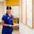 Doctor with stethoscope around neck holding piece of paper and smiling