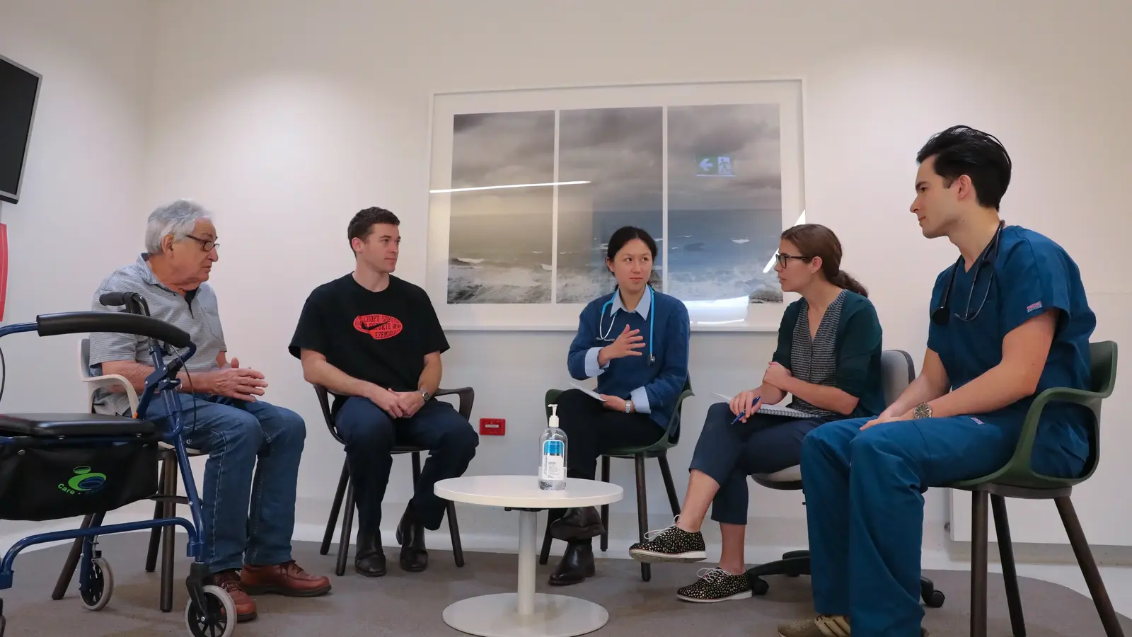 Five medical professionals having a discussion