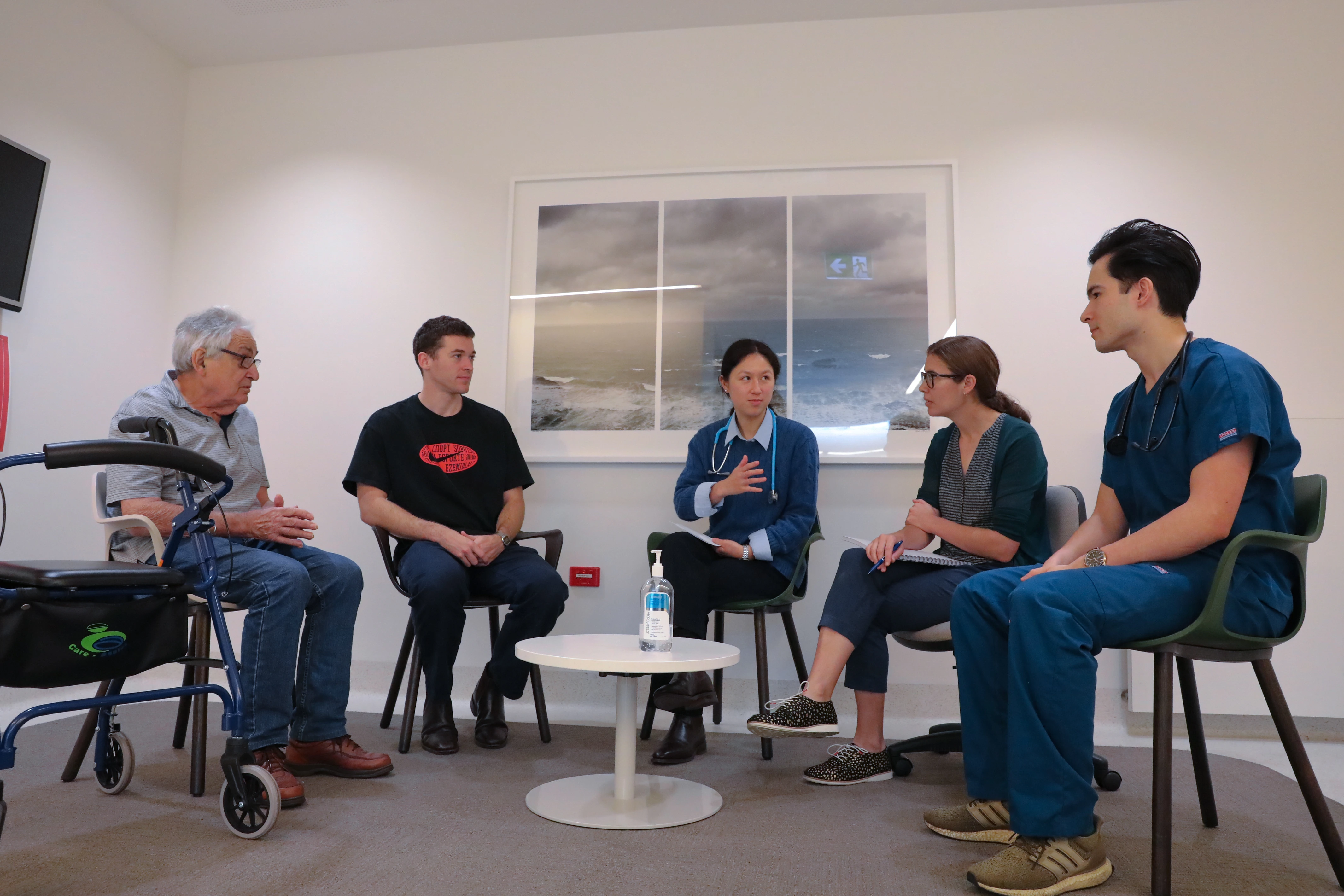 Five medical professionals having a discussion