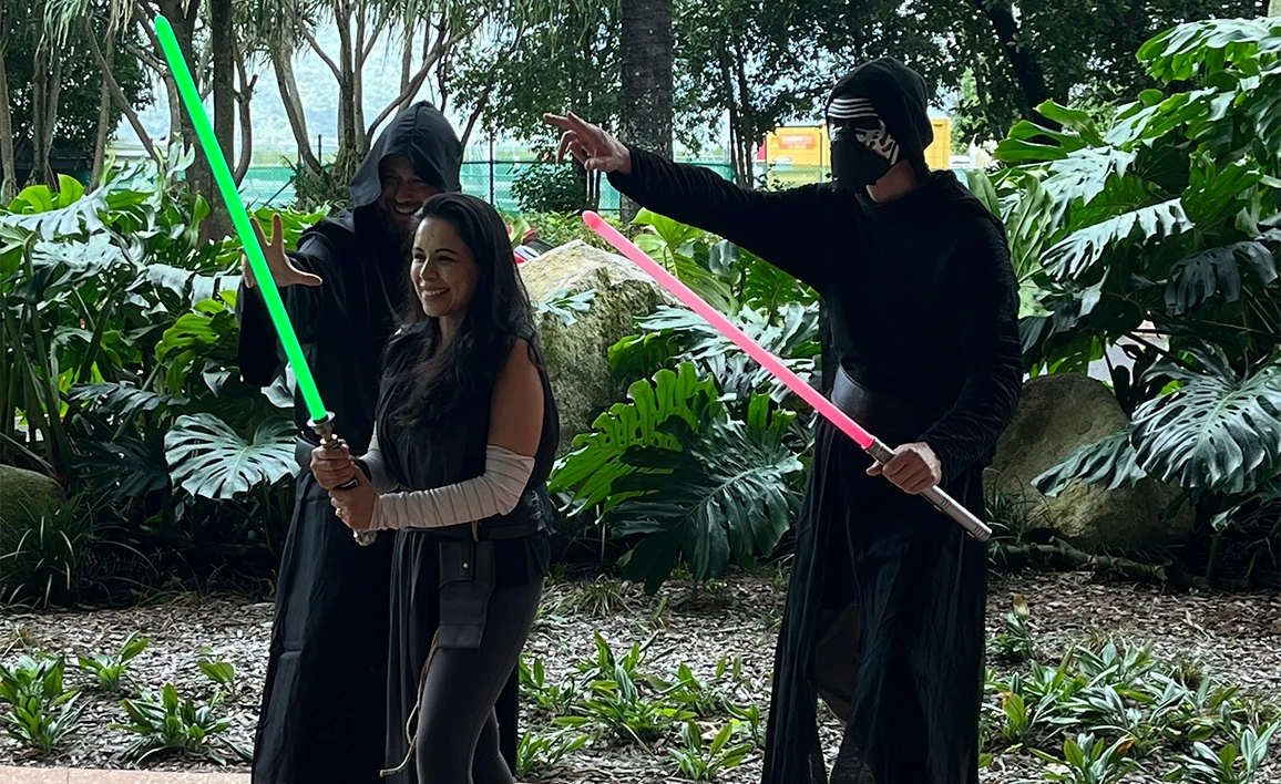 Three people dressed as Jedi