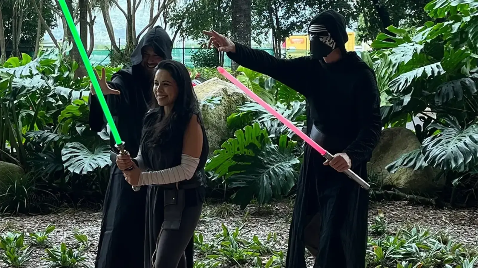 Three people dressed as Jedi