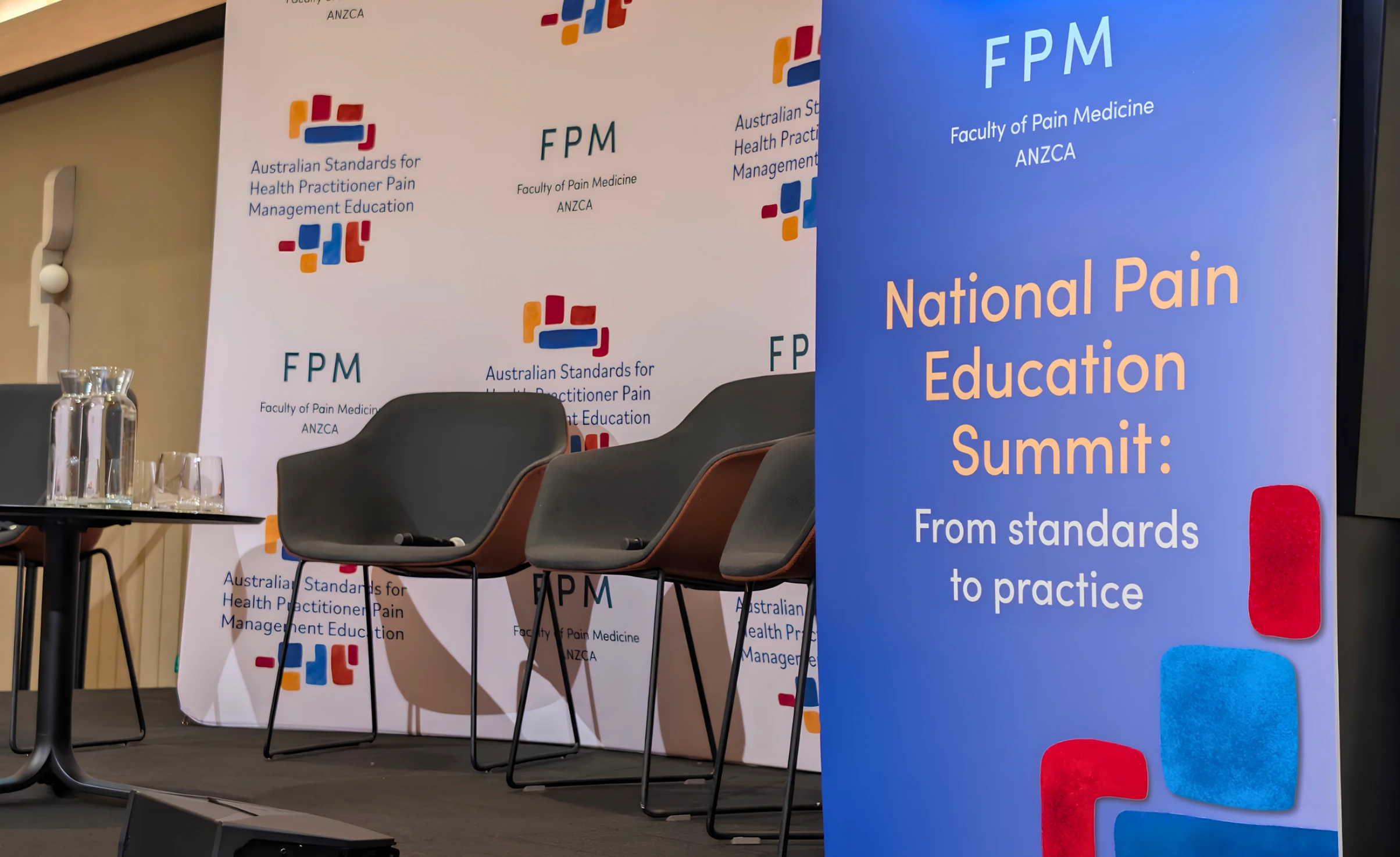 The FPM National Pain Education podium and panelist chairs