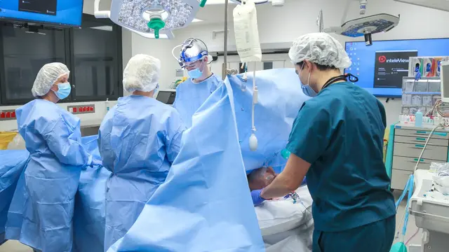 Doctors operating on patient in theatre