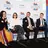 A photo of a speaking panel in front of an FPM and Education standards media wall