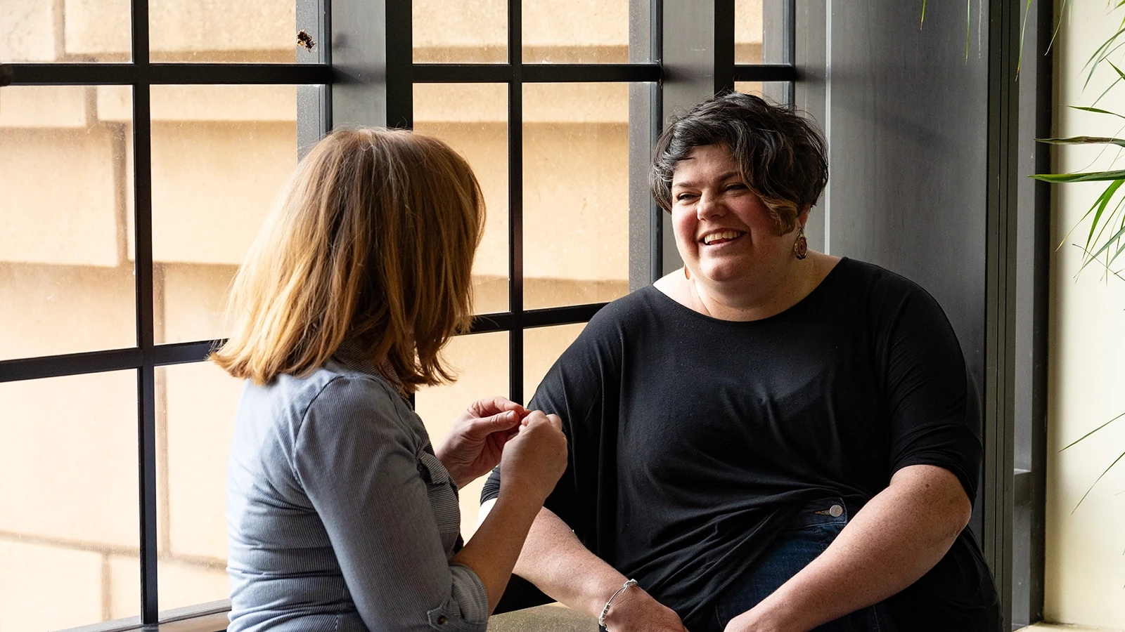 Research coordinator Tash Brice talking to Hannah Cozens