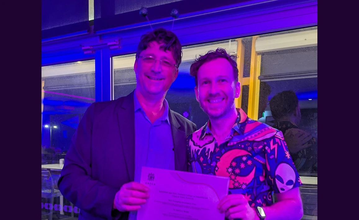 Prof Dave Story awarding Dr Matthew Bright the prize certificate