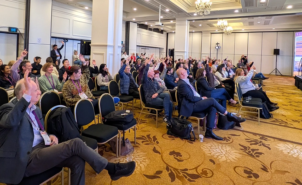 Delegates voting with show of hands at the great debate session at the 2025 CTN workshop in Glenelg, SA