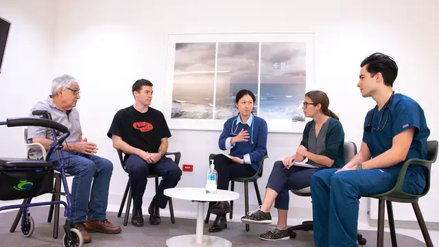 Doctors talking with patient and carer