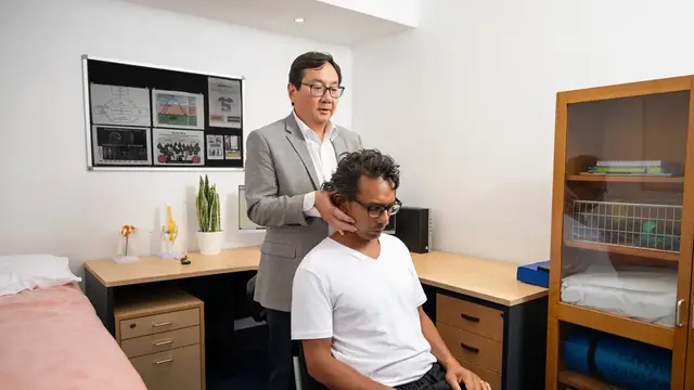 Doctor adjusting patient's neck 