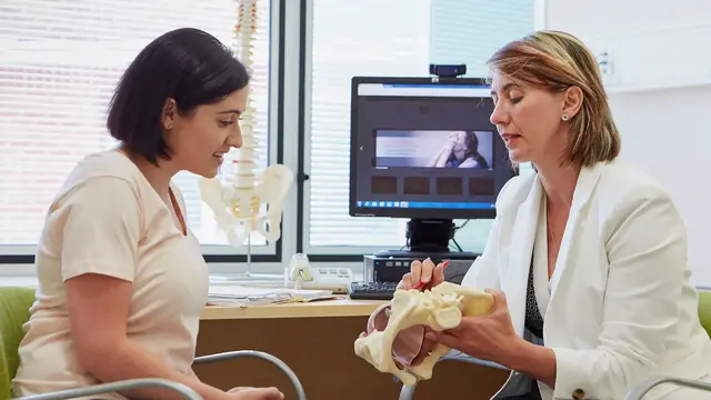 Specialist pain medicine physician talking to patient in clinic
