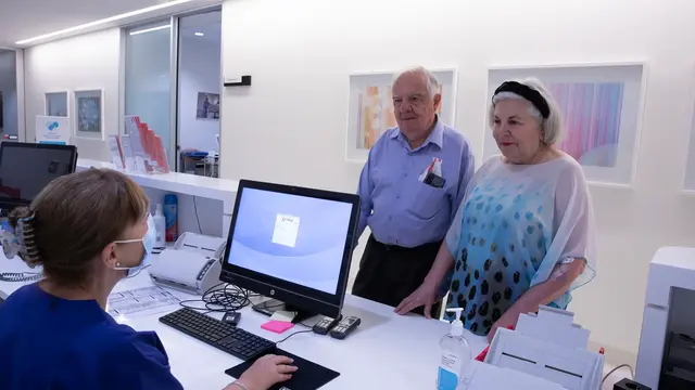Patients talking to medical receptionist