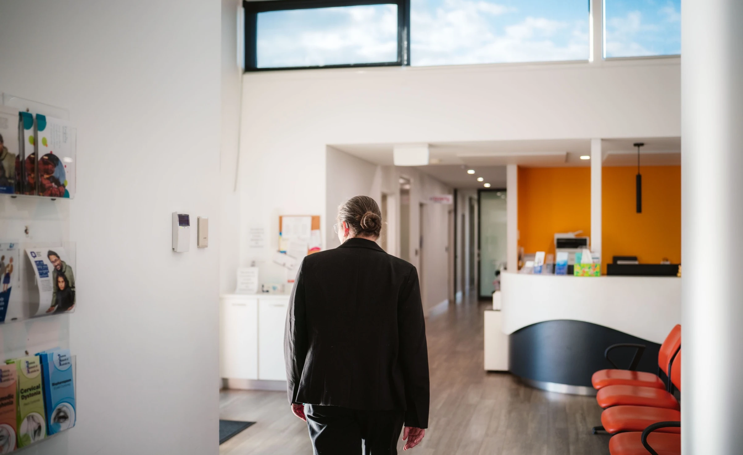 A photo of a woman walking through a regional pain clinic in Tamworth, NSW.