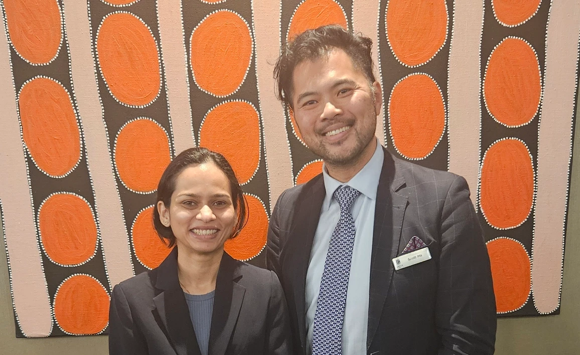 Two people smiling at the camera