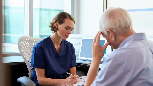 A female doctor discusses pain options with an older man
