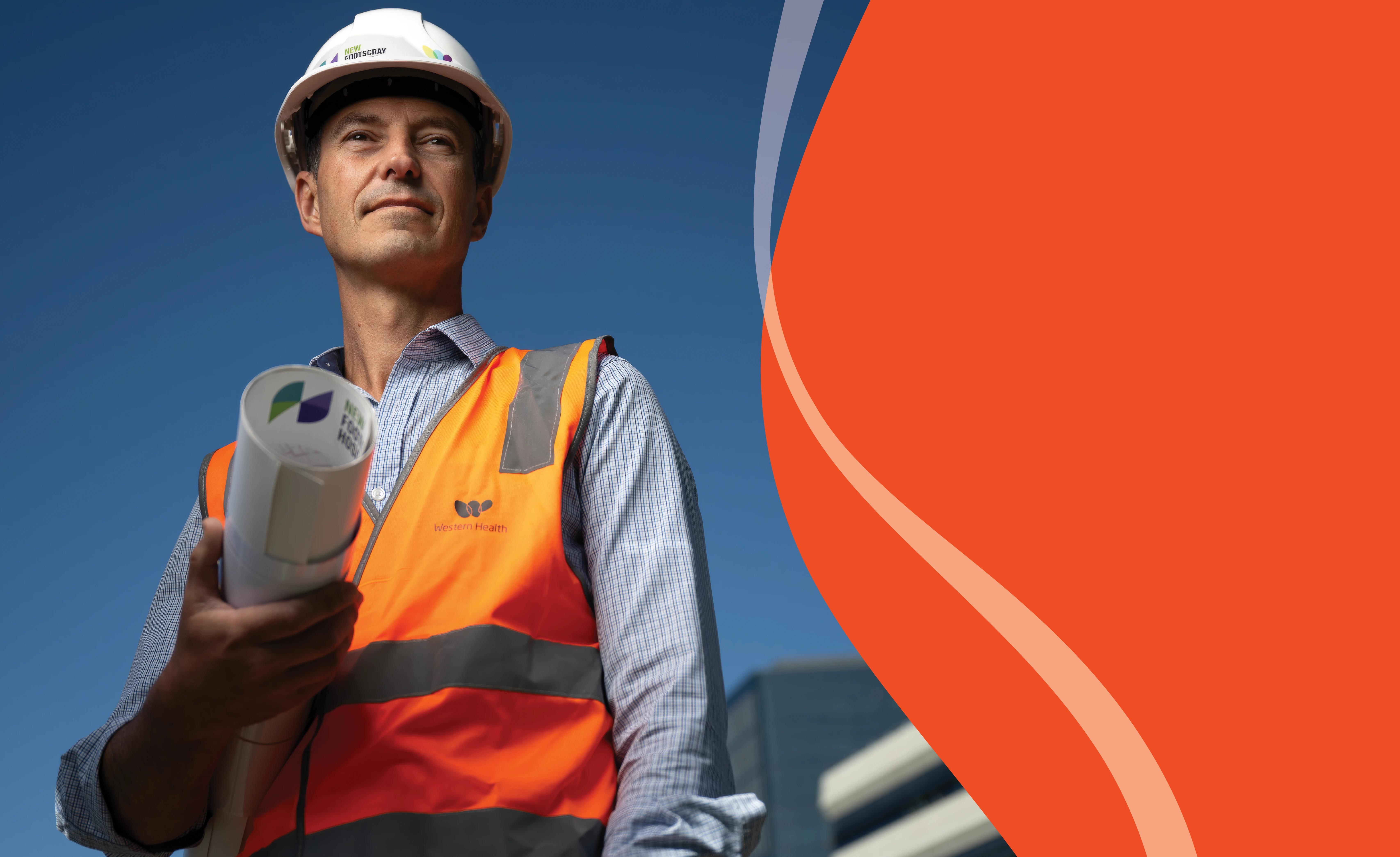 Man in hard hat with architectural plans