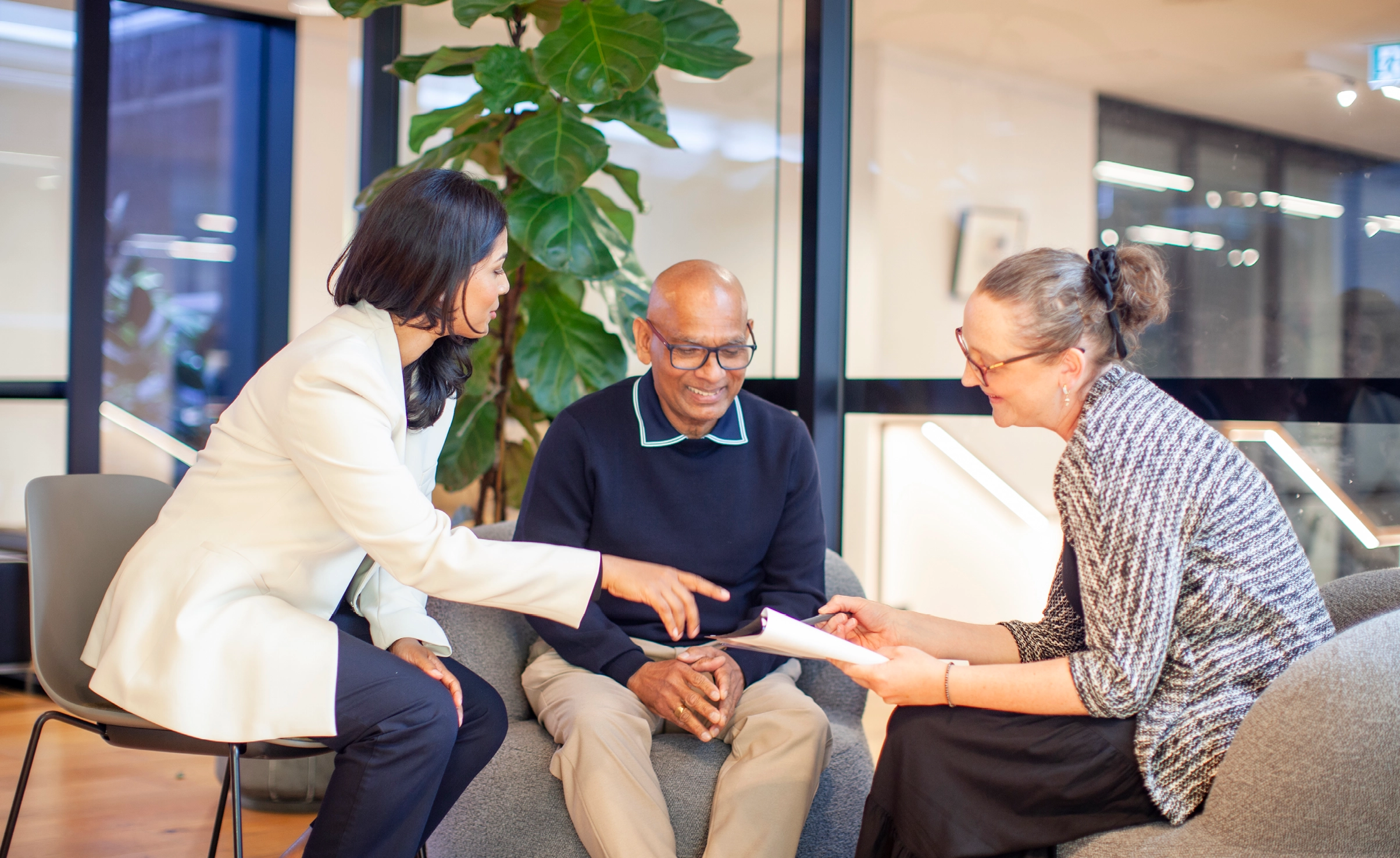 Three seated people having a discussion