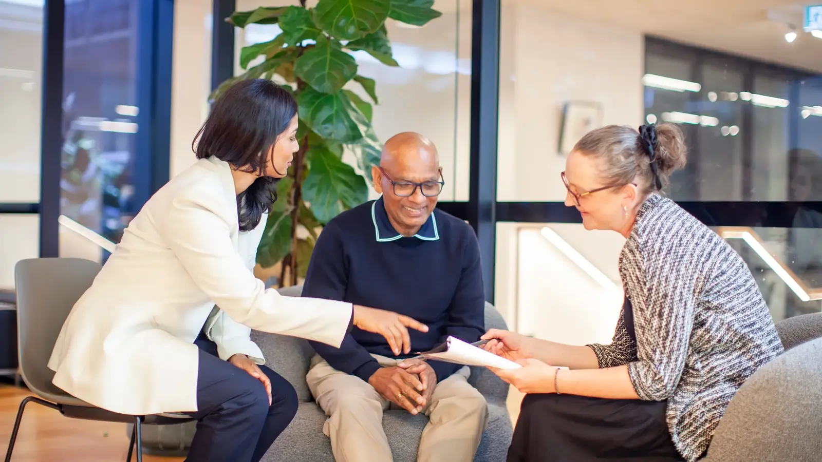 Three seated people having a discussion 
