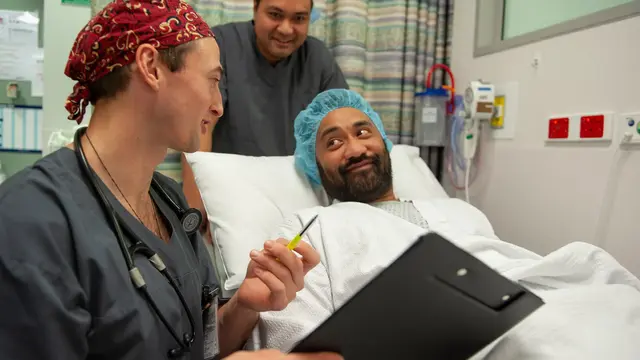 Anaesthetist talking to patient in hospital