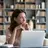 Woman sitting reflectively at computer