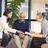 A patient and their carer discussing a clinical trial with a research coordinator.