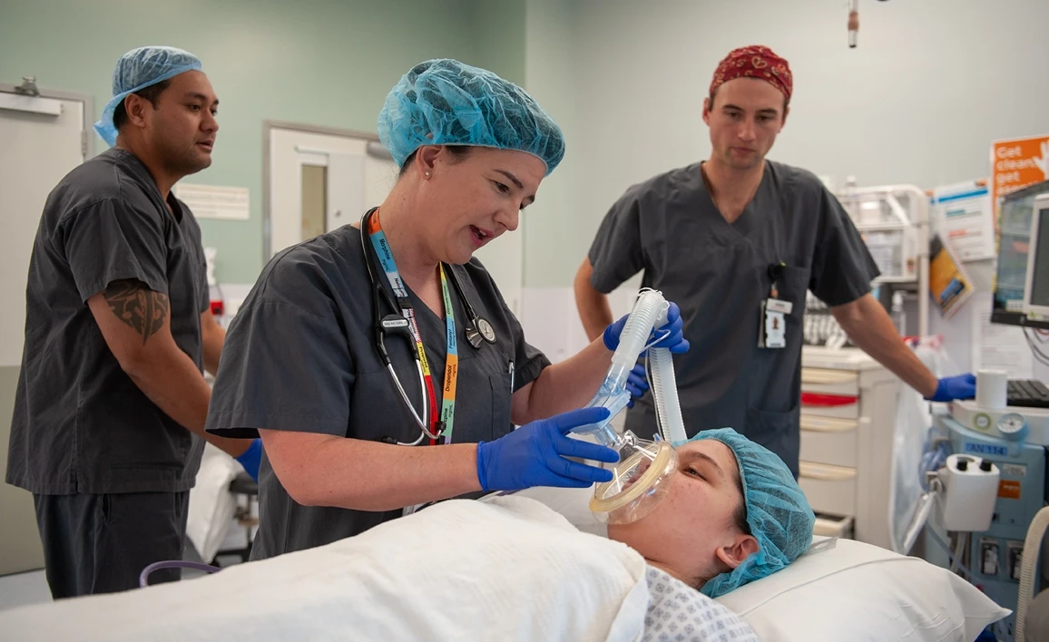 Anaesthetist next to patient in operating theatre