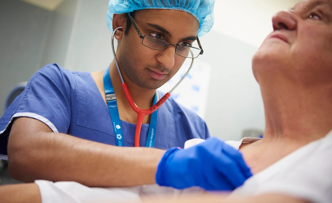 Doctor checking patient's heart